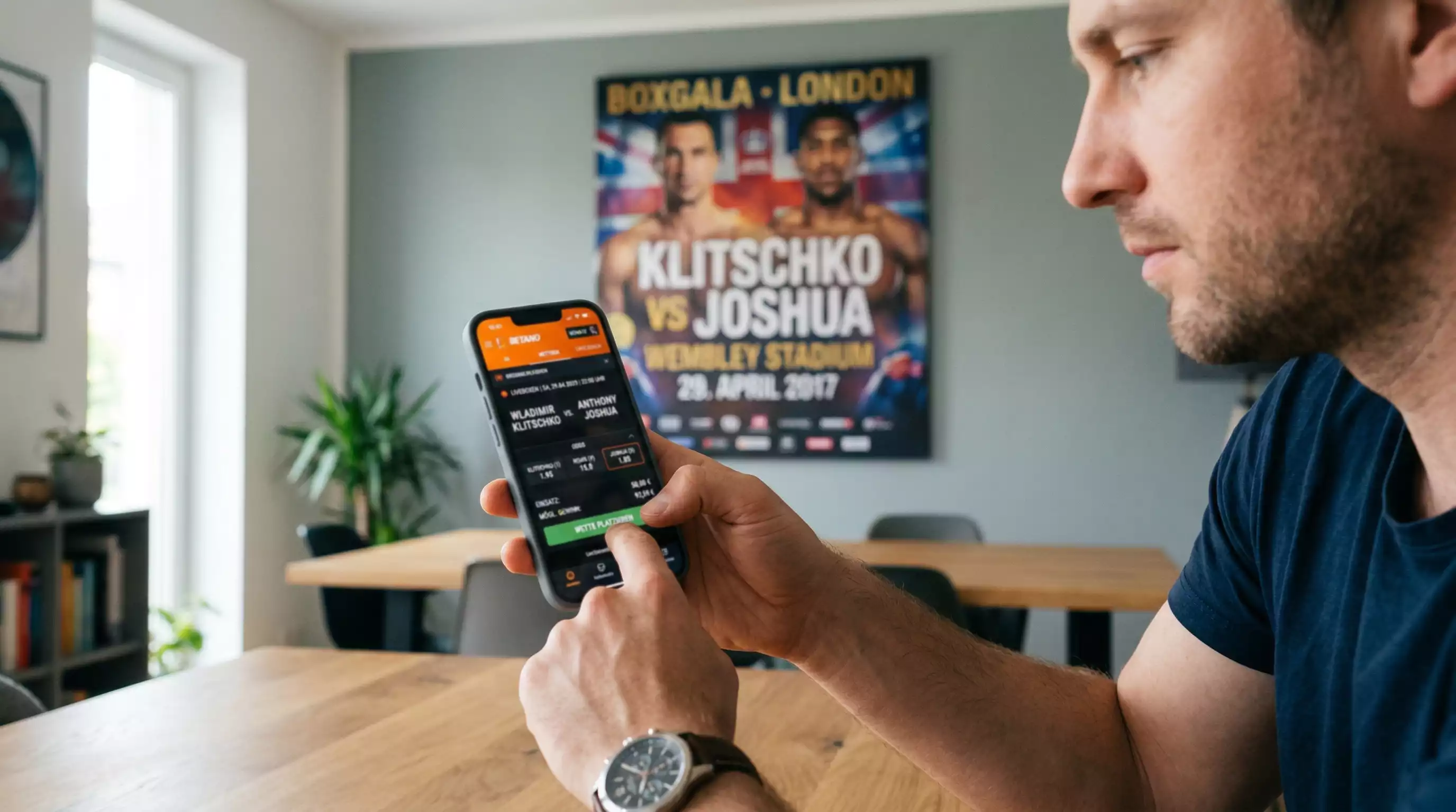 Person tippt eine Sportwette auf dem Smartphone vor einem Boxplakat